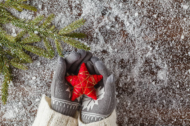 istock xmass red stars in girl hands 628065254