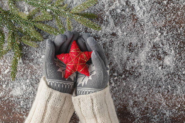 istock xmass red stars in girl hands 628065324