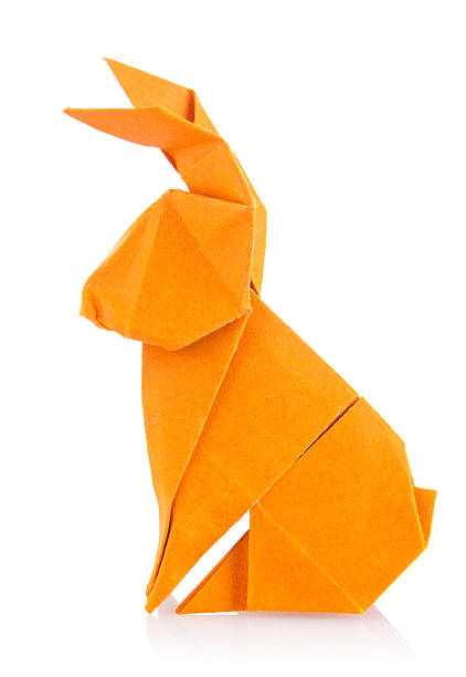 Easter bunny of orange origami Easter bunny of orange origami. Isolated on white background rabbit animal photos stock pictures, royalty-free photos & images