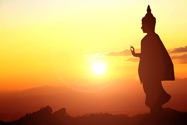Buddha statue on sunset sky background at Thailand
