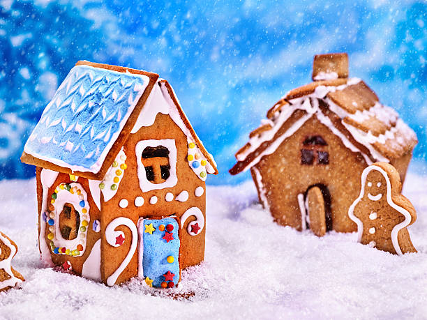 istock Two cookie houses and gingerbread man. 628067868