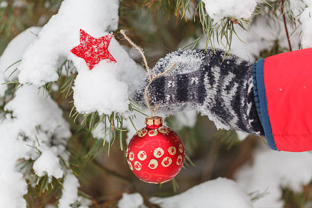 istock Man decorates a fur-tree in winter wood 628068142