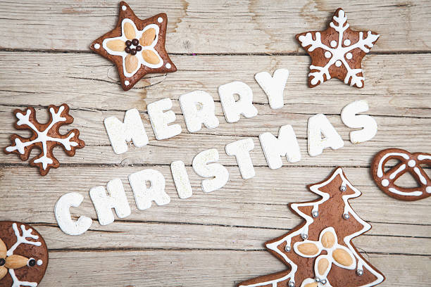 istock Christmas grey wood background with gingerbread and Merry 628068284