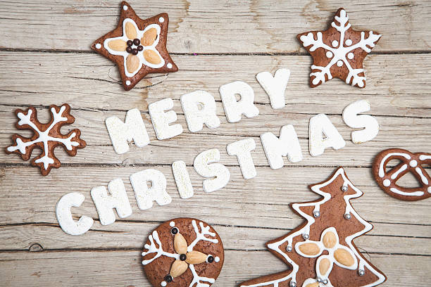 istock Christmas grey wood background with gingerbread and Merry 628068356