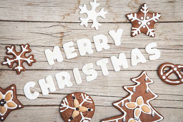 istock Christmas grey wood background with gingerbread and Merry 628068448