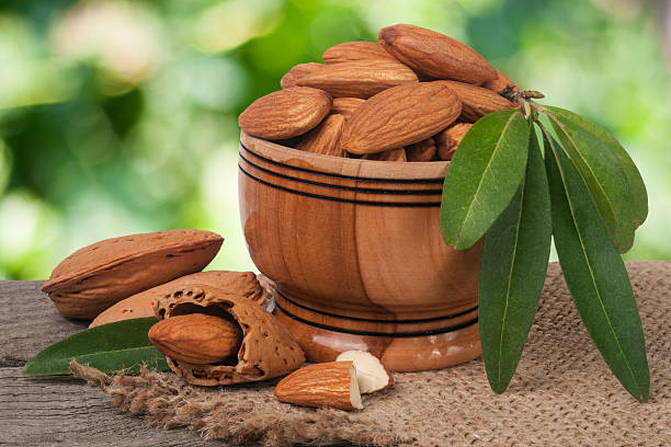 istock almonds in a bowl on the old wooden board with 628068526