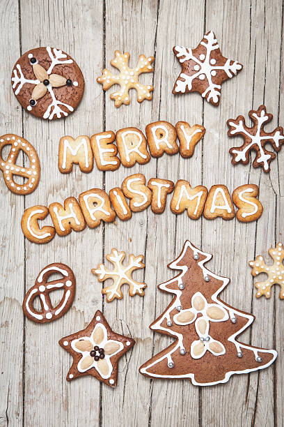 istock Christmas grey wood background with gingerbread and Merry 628068710