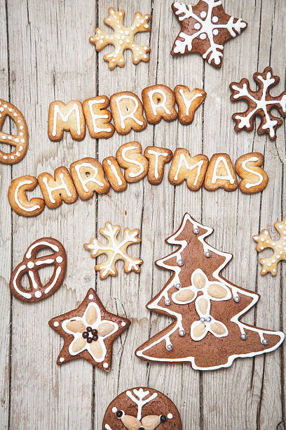 istock Christmas grey wood background with gingerbread and Merry 628068786