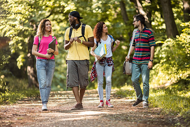istock Small group of students walking in nature and communicating. 628069604