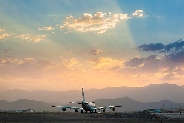 istock Jumbo Jet on the runway at sunset 628076664