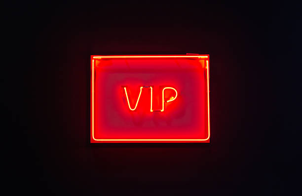 istock Luminous neon sign of VIP on a dark background 628077708