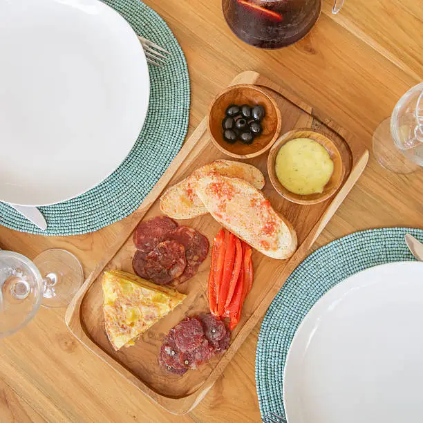 Photo of Top view of tapas and sangria on the table