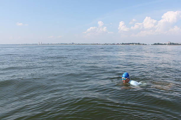The young man swimming in the river