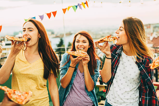 istock Eating pizza at a party on the roof 628078218
