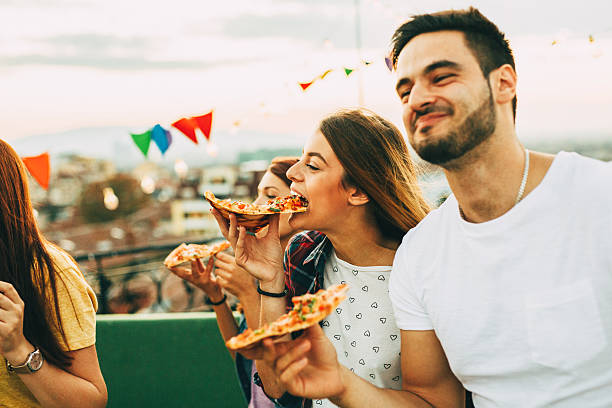 istock Eating pizza at a party on the roof 628078304
