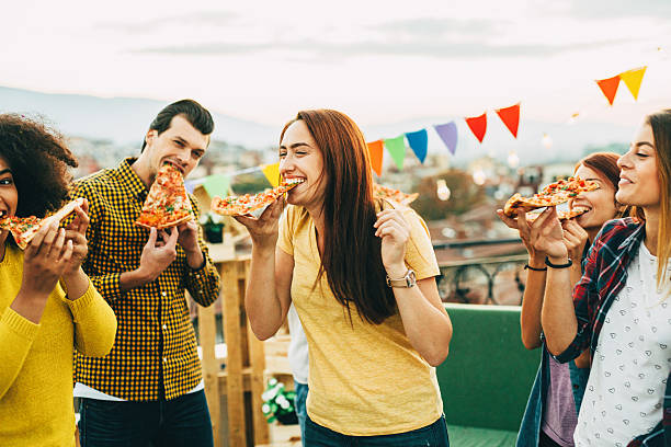 istock Eating pizza at a party on the roof 628078424