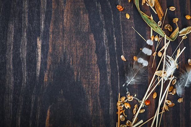 istock Wooden background with hay, feathers and grains millet. 628078658