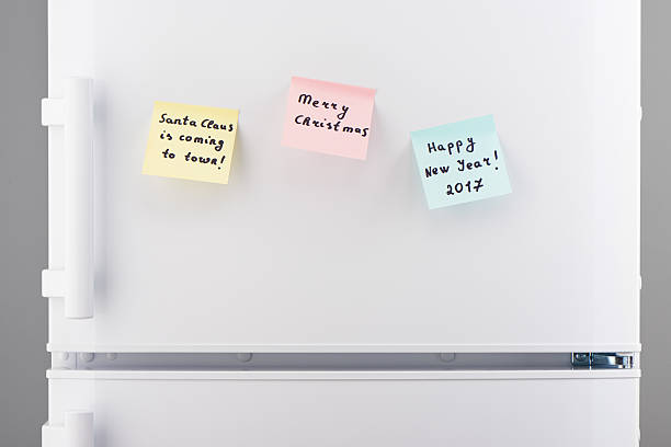 istock Christmas and New Year notes on white refrigerator door 628078792
