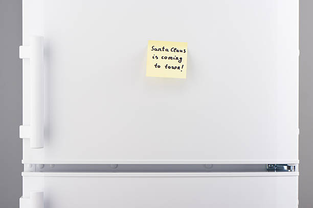 istock Santa Clause is coming to town note on white refrigerator 628078866
