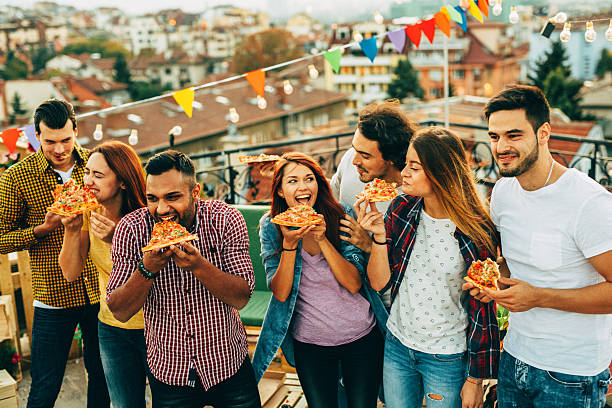 istock Eating pizza at a party on the roof 628078994