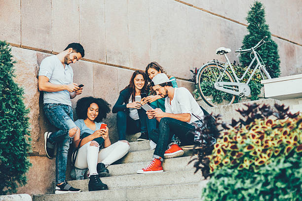 istock Friends browsing the net outdoors 628084034