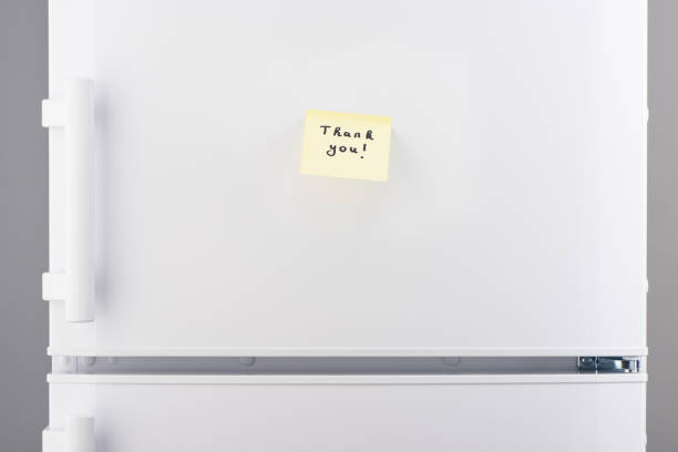 istock Thank you note on yellow sticky paper on white refrigerator 628084060