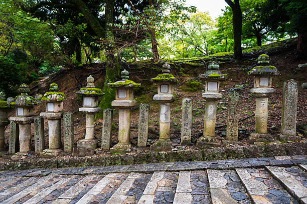 Nara, Japan - December 30, 2016: Kasuga Taisha Shrine’s Kasuga style Tōrō lantern. A lantern dedicated to Kasuga Taisha as gifts. The style in which a lantern is placed on a high foundation of stone is called Kasuga type. Kasuga Shrine is founded in 768. It is registered as a UNESCO World Heritage Site as part of the Historic Monuments of Ancient Nara.