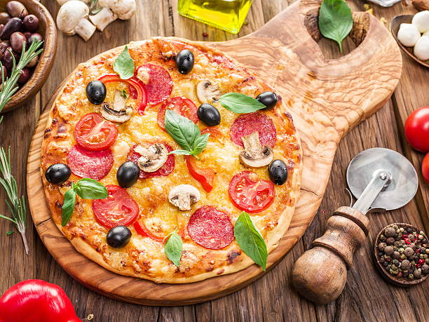 istock Pizza with mushrooms, salami and tomatoes. 628084506