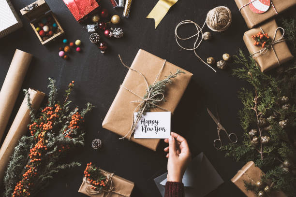 istock Wrapping New Year gifts, table top flat lay 628085846