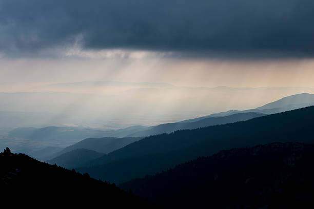 istock Layered mountain slopes and clouds in blue shades 628086644
