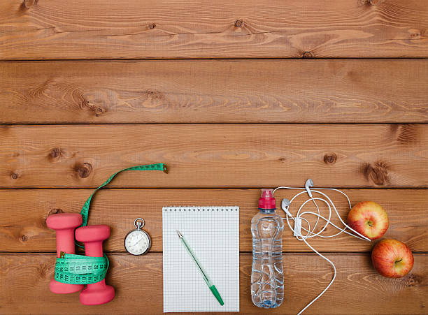 istock Apple, dumbbell, water,  stopwatch measuring  tape and headphon 628086764