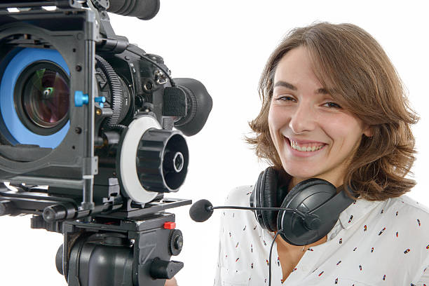 istock beautiful young woman with SLR video camera 628087104