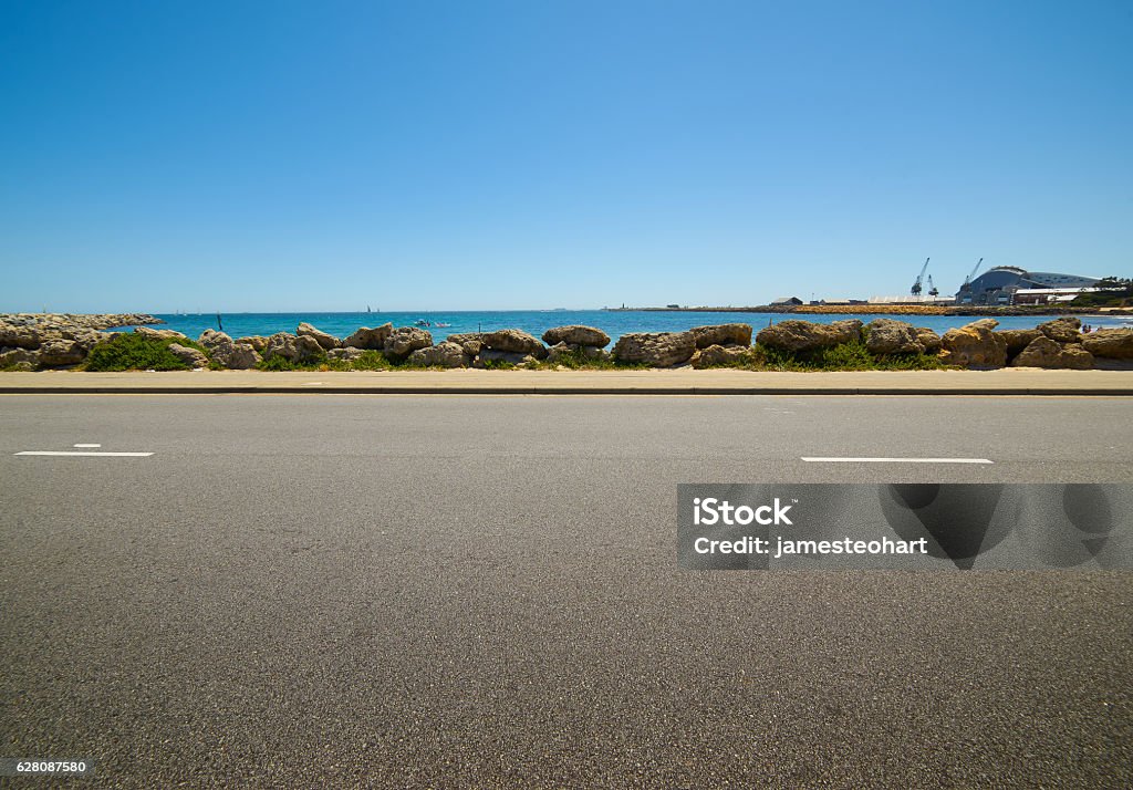 sunny summer day near the water asphalt road on Asphalt Stock Photo