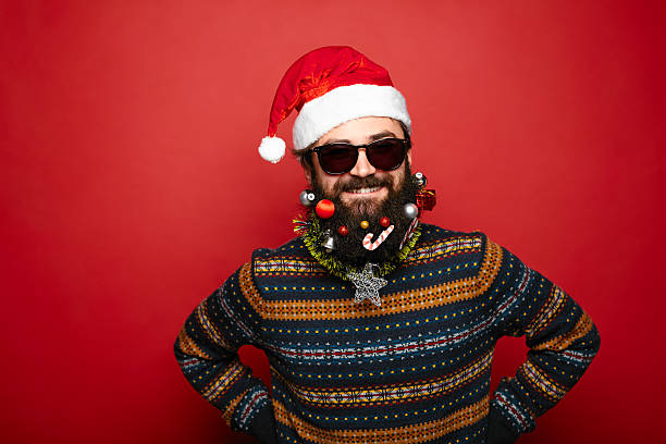 istock Cool man dressed as Santa Claus over red background 628087914