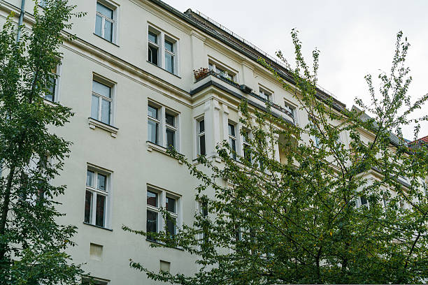 istock luxury apartment building with beautiful green tree 628088636