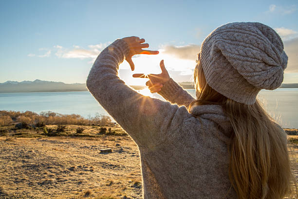 istock Young woman framing sunrise 628089678