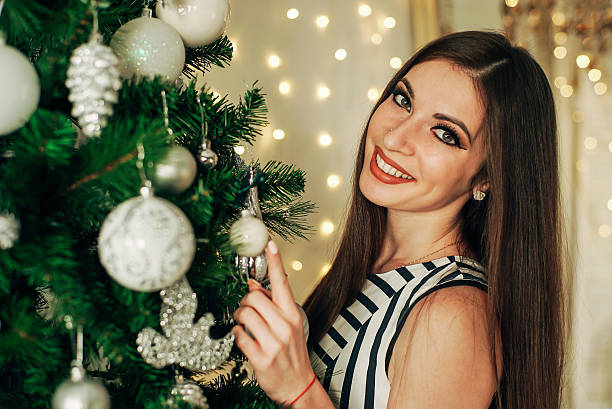 istock girl hangs on a Christmas tree ball 628089822