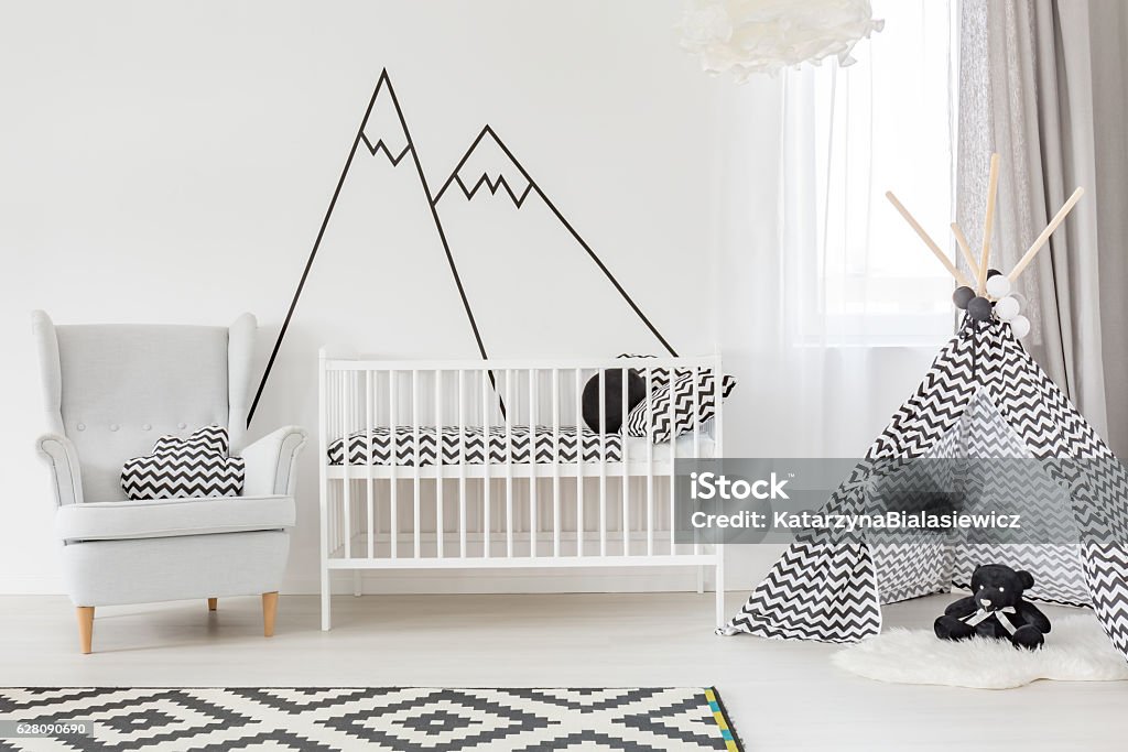 White baby room with cot White baby room with cot, armchair and play tent Baby - Human Age Stock Photo