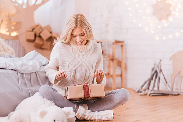 istock Positive curious woman opening a Christmas box 628091422