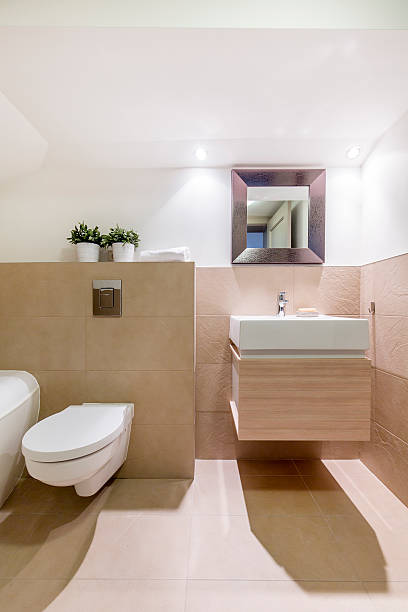 istock Travertine bathroom with toilet and sink 628092078