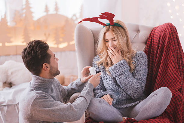 Surprised astounded woman looking at the engagement ring