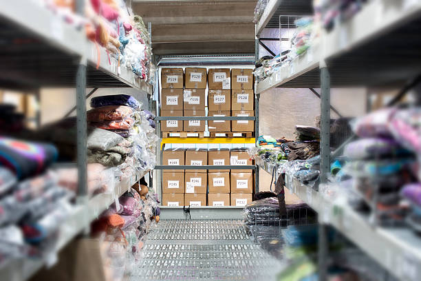 Wholesaling warehouse A part of wholesaling warehouse with clothes on the shelves and stored numbered boxes. bizarre fashion stock pictures, royalty-free photos & images
