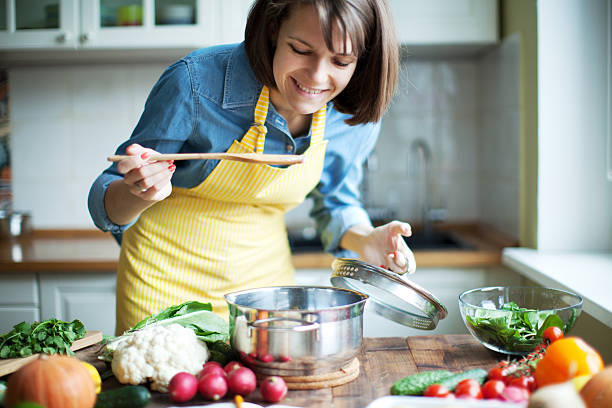 Dinner Woman cooking woman making healthy dinner stock pictures, royalty-free photos & images
