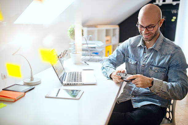 istock Photographer in his office 628098822