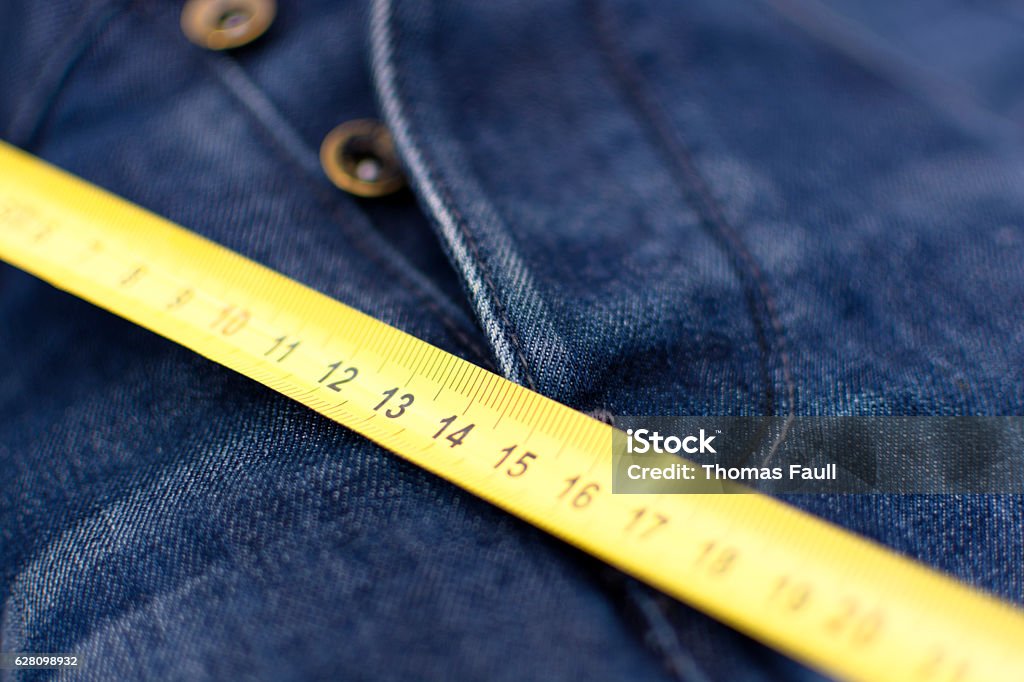 Man Measuring Things, Jeans Crotch A tape measure by the crotch of a pair of male jeans. Scale in centimetres. Anatomy Stock Photo