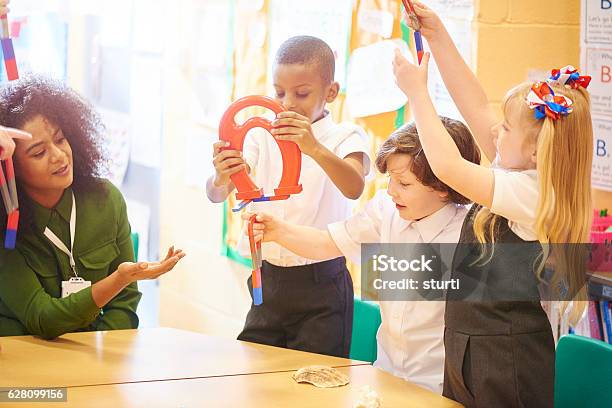 Magnetic Field Science Stock Photo - Download Image Now - Magnet, Elementary Age, Group Of People