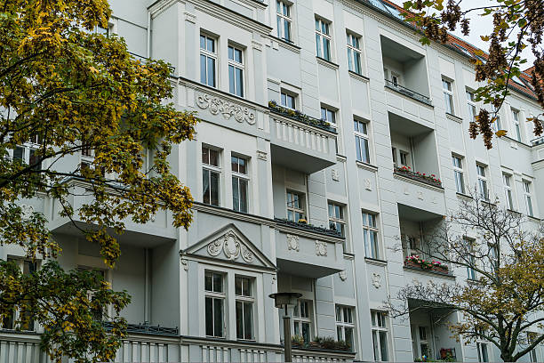istock apartment building framed with autumn trees 628100624