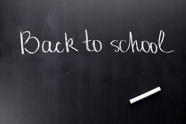 istock Chalkboard with back to school written in white chalk 628101372