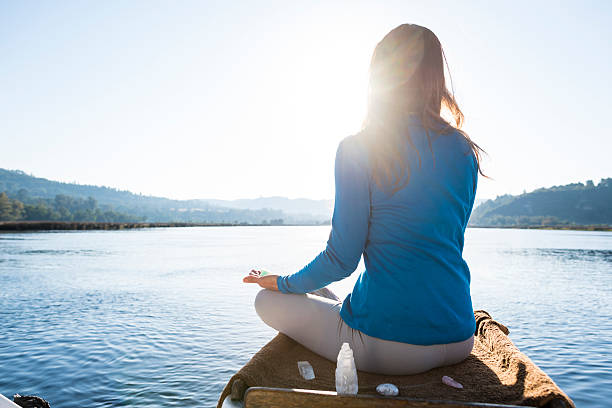 istock Woman Meditating On A Calm Lake 628102158