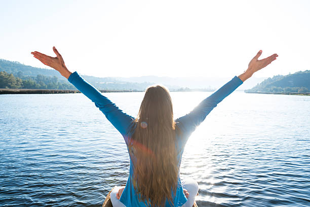istock Woman Meditating On A Calm Lake 628108424